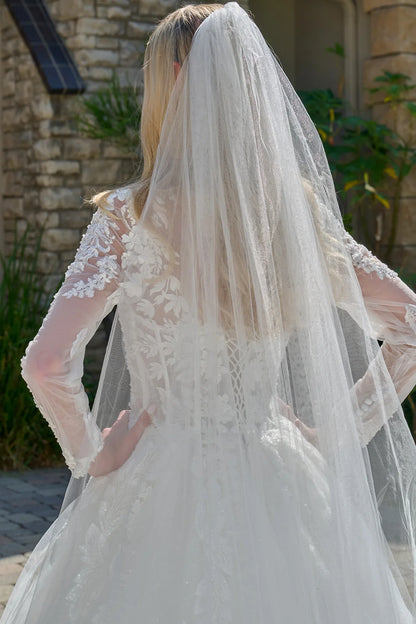 Wedding Dress Made Of Transparent Mesh, With Long Sleeves, A Round Neckline, And A Corset-Style Bodice.